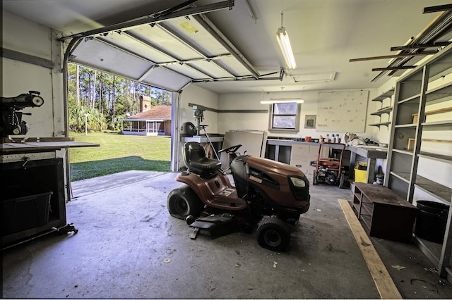 garage with a workshop area and a lawn