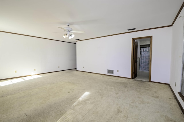 spare room with ceiling fan, light colored carpet, and ornamental molding