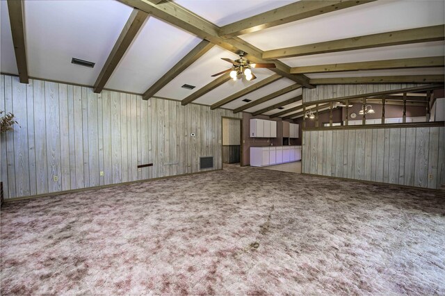 unfurnished room with wood walls and carpet