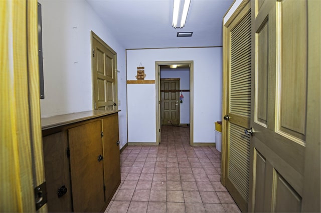 corridor with light tile patterned floors