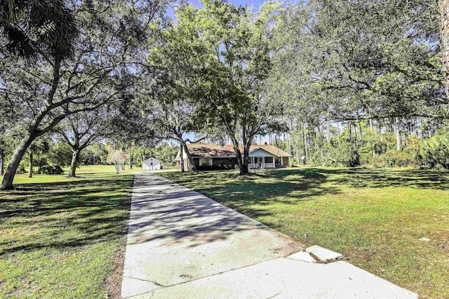 view of front facade with a storage unit and a front yard