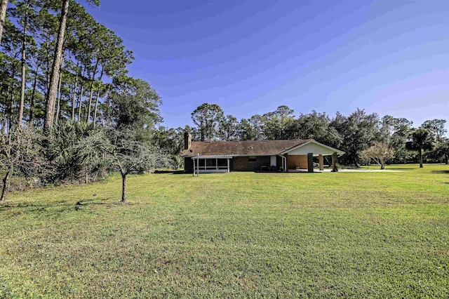 view of yard with a sunroom