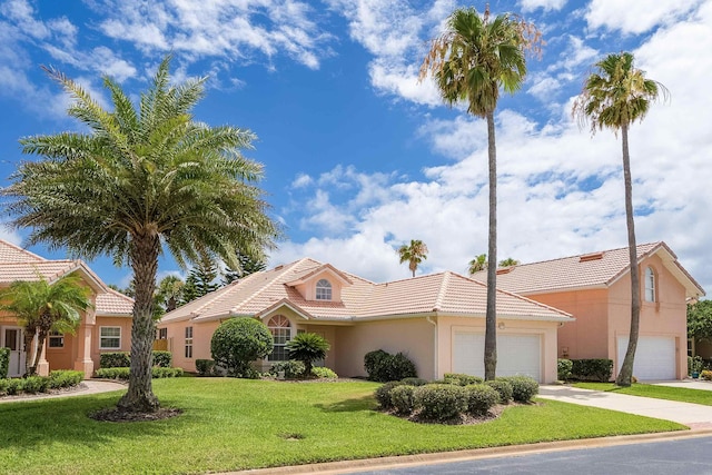 view of front of home featuring a front lawn and a garage