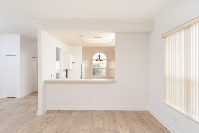 unfurnished room with light wood-type flooring and crown molding