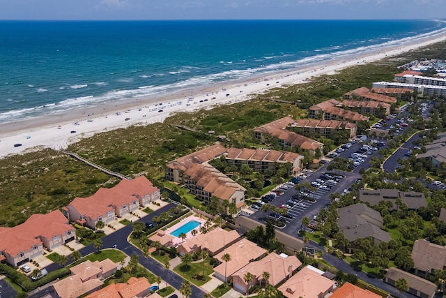 bird's eye view featuring a water view and a beach view