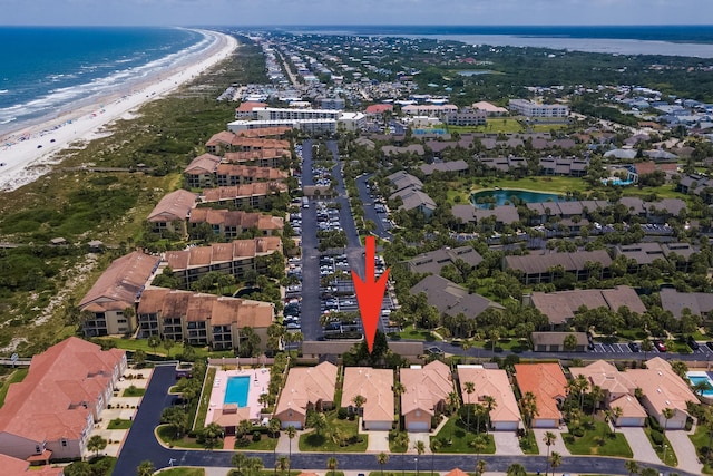 drone / aerial view featuring a water view and a beach view