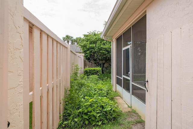 view of side of home featuring a sunroom