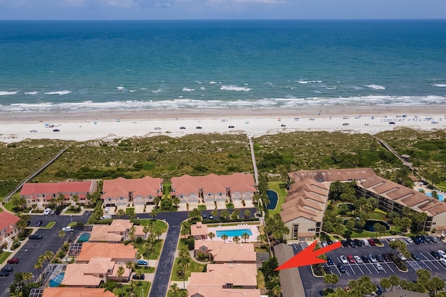 drone / aerial view with a water view and a beach view