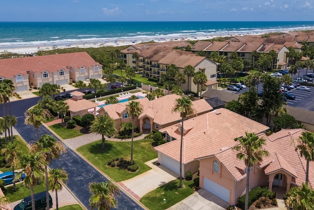 birds eye view of property with a water view and a view of the beach