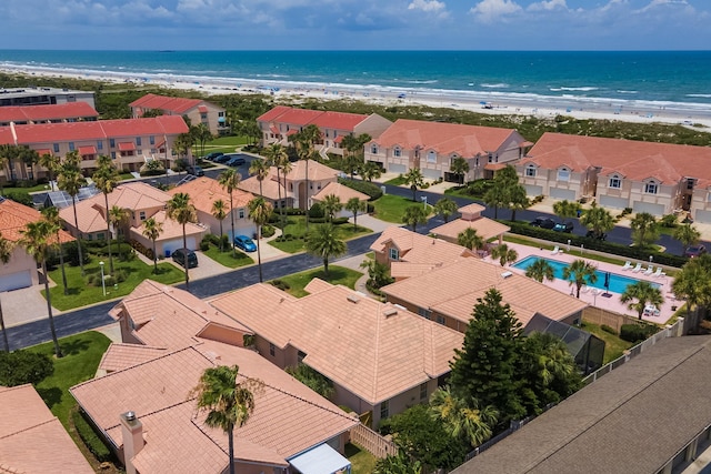 drone / aerial view featuring a water view and a beach view