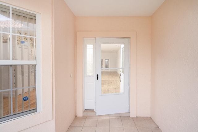 doorway with light tile patterned flooring