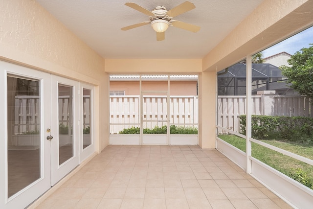 unfurnished sunroom featuring french doors and ceiling fan