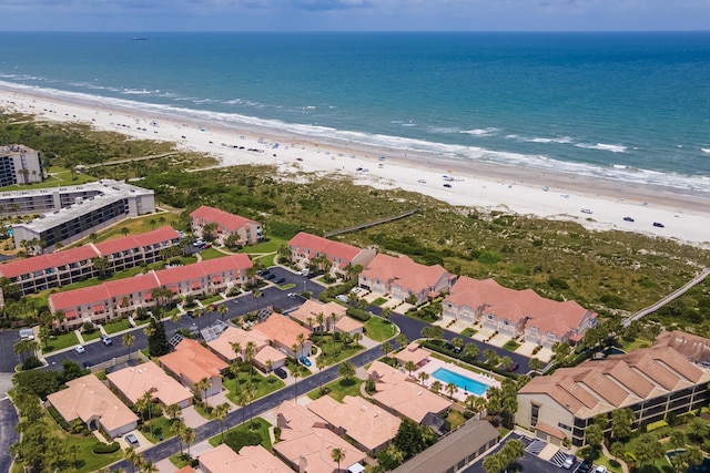 birds eye view of property featuring a water view and a beach view