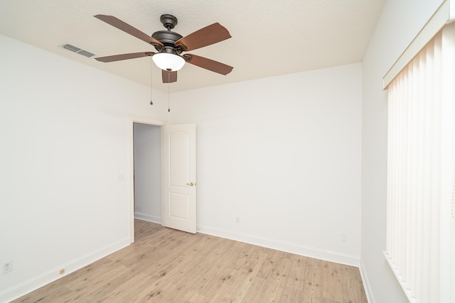 unfurnished room with ceiling fan and light wood-type flooring