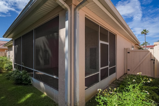 view of side of home with a sunroom