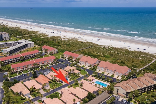 birds eye view of property featuring a beach view and a water view