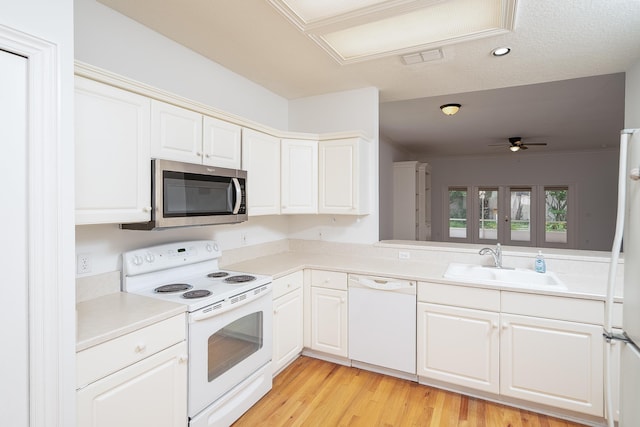 kitchen featuring ceiling fan, sink, light hardwood / wood-style floors, white appliances, and white cabinets