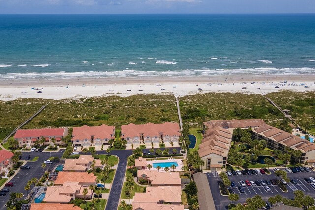 drone / aerial view featuring a view of the beach and a water view