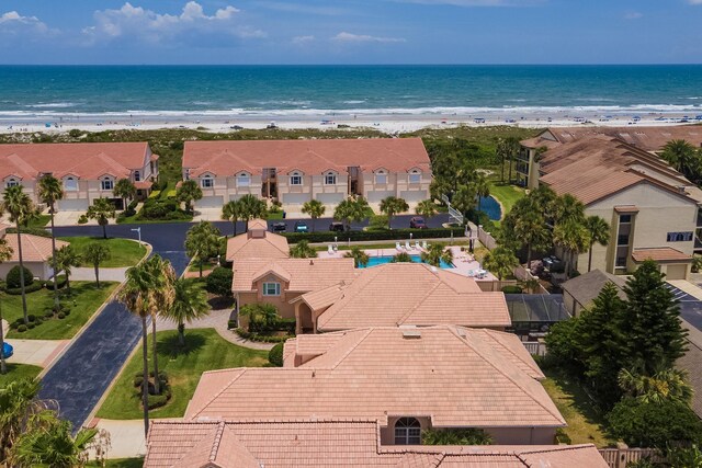 aerial view with a water view and a beach view