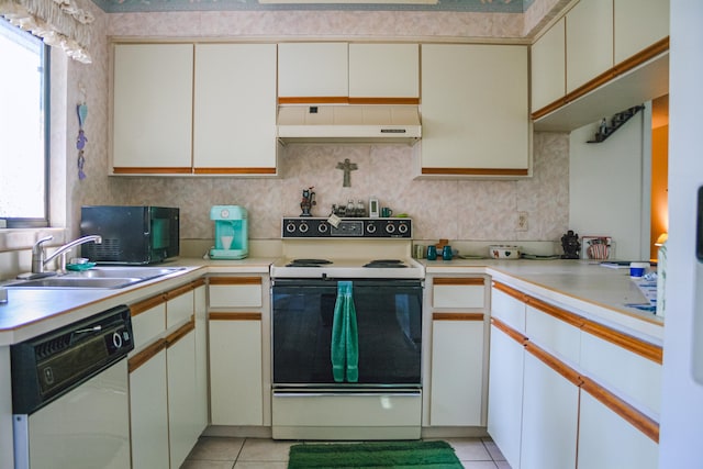 kitchen with dishwasher, electric stove, light countertops, under cabinet range hood, and a sink