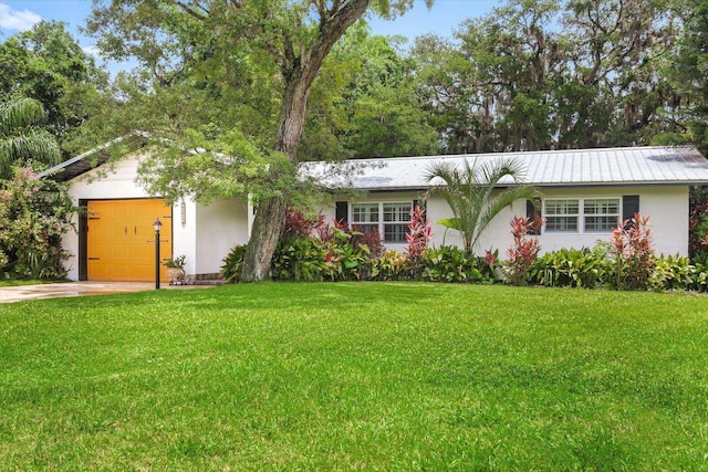 605 A St, Saint Augustine, FL 32080 - ranch-style home with a garage, a front yard, stucco siding, and driveway