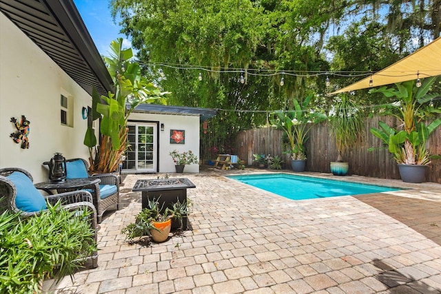 605 A St, Saint Augustine, FL 32080 - view of swimming pool with an outdoor fire pit, a patio, and a fenced backyard