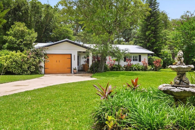 605 A St, Saint Augustine, FL 32080 - ranch-style house with driveway, an attached garage, a front lawn, and a metal roof