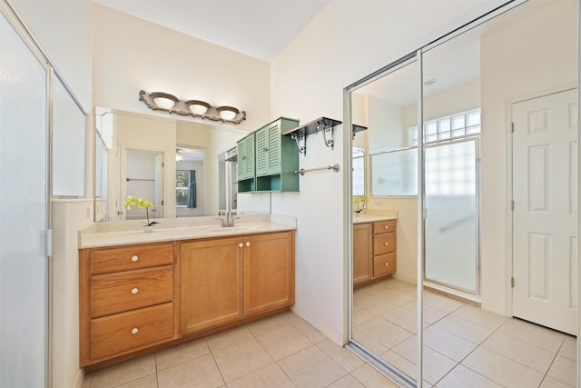 bathroom with a shower stall, vanity, and tile patterned floors