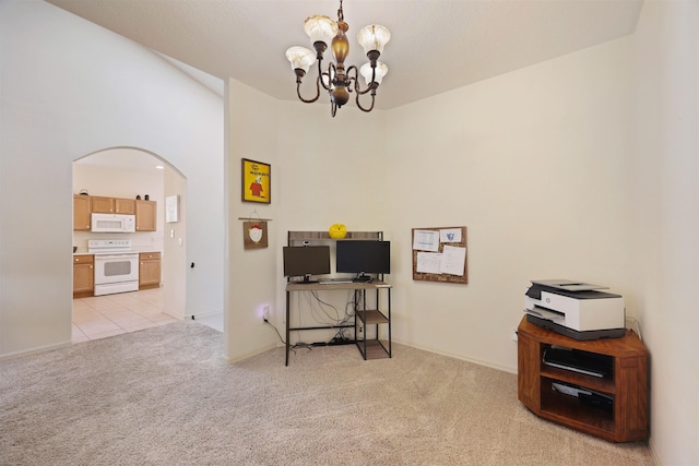 office with light carpet, an inviting chandelier, light tile patterned floors, and arched walkways