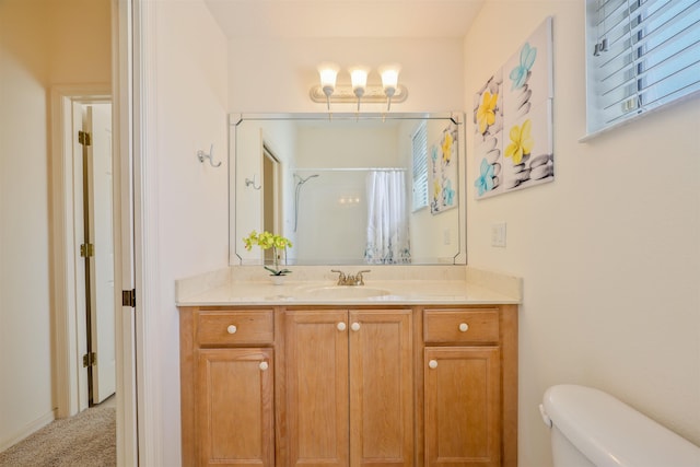 full bath featuring toilet, curtained shower, and vanity