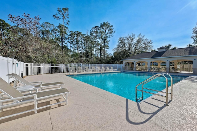 pool featuring a patio and fence