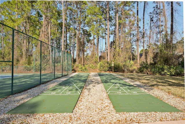 surrounding community featuring fence and shuffleboard