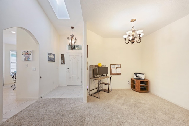 carpeted entryway featuring arched walkways, high vaulted ceiling, tile patterned floors, and an inviting chandelier