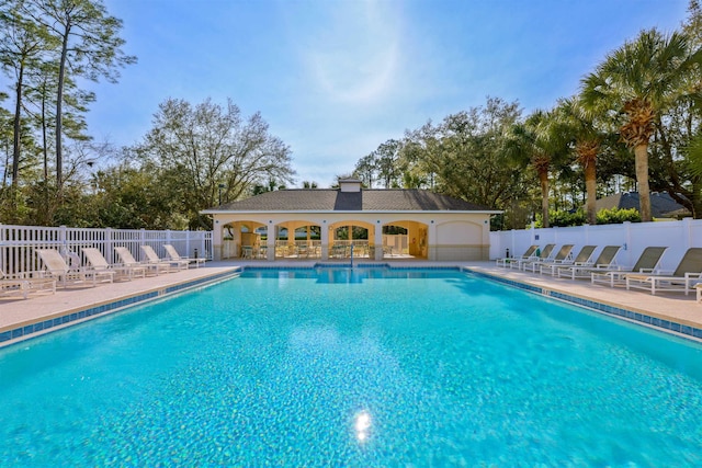 community pool featuring fence and a patio