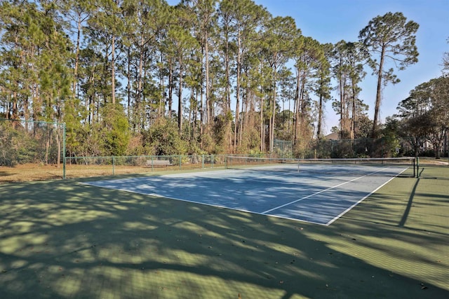 view of tennis court with fence