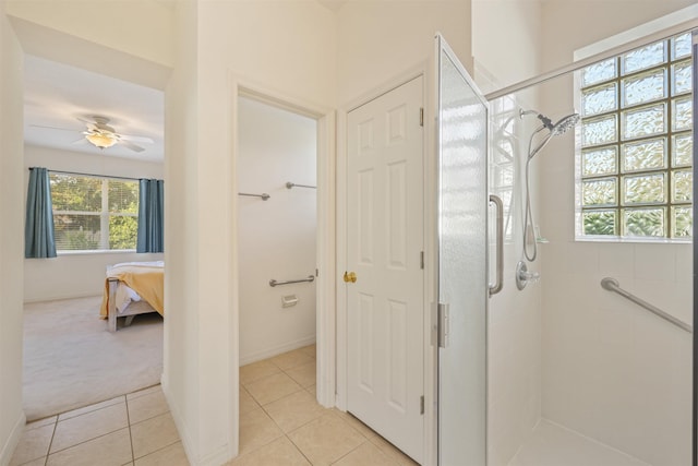 ensuite bathroom with a stall shower, ensuite bath, ceiling fan, and tile patterned floors