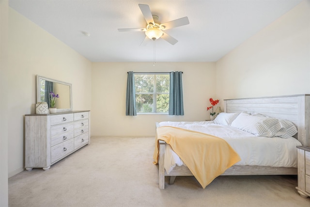 bedroom featuring a ceiling fan and light colored carpet