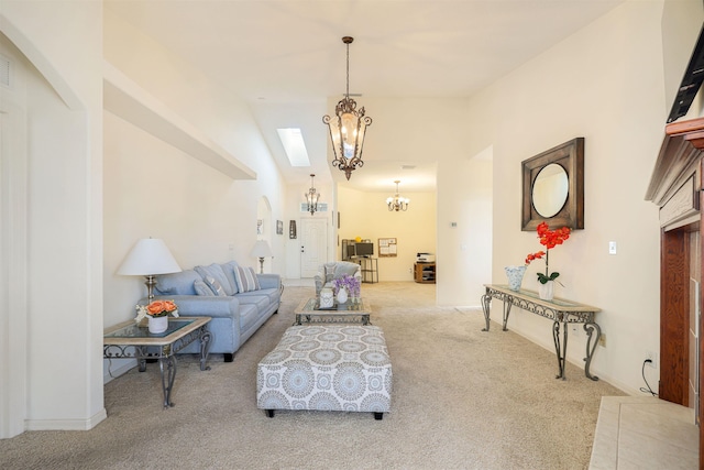 living area featuring arched walkways, carpet, and an inviting chandelier