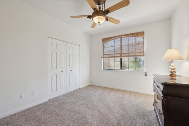 bedroom featuring ceiling fan, a closet, and light colored carpet