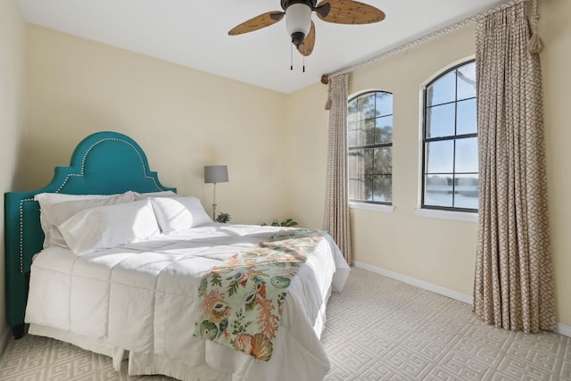 bedroom with ceiling fan and light carpet