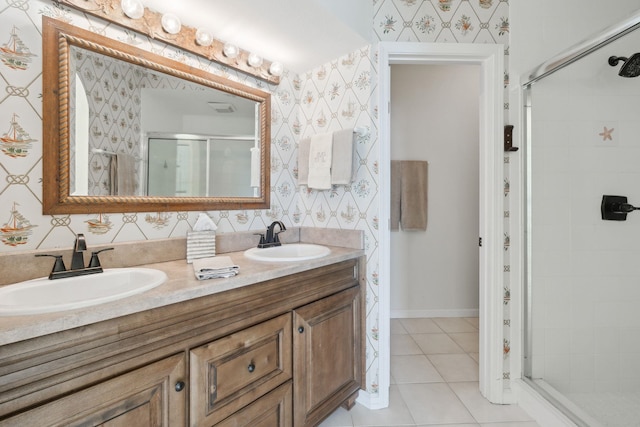 bathroom with tile patterned floors, a shower with door, and vanity