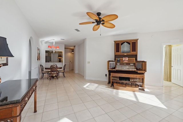 interior space featuring ceiling fan with notable chandelier