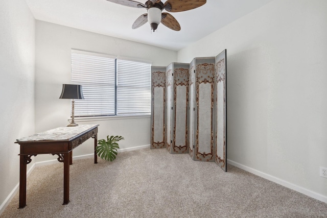 living area featuring light colored carpet and ceiling fan