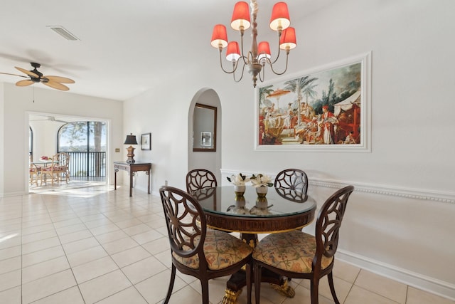 dining space with light tile patterned flooring and ceiling fan with notable chandelier