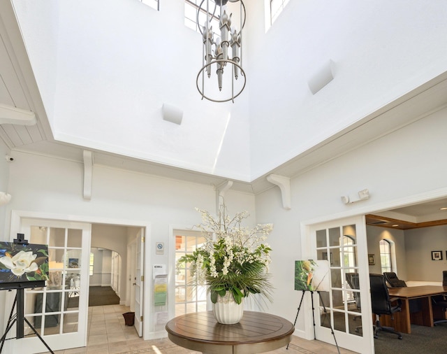 tiled dining room with a high ceiling and french doors