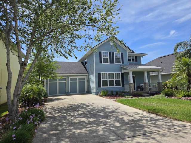 517 Weeping Willow Ln, Saint Augustine, FL 32080 - view of front of property featuring a porch, driveway, an attached garage, and a front yard