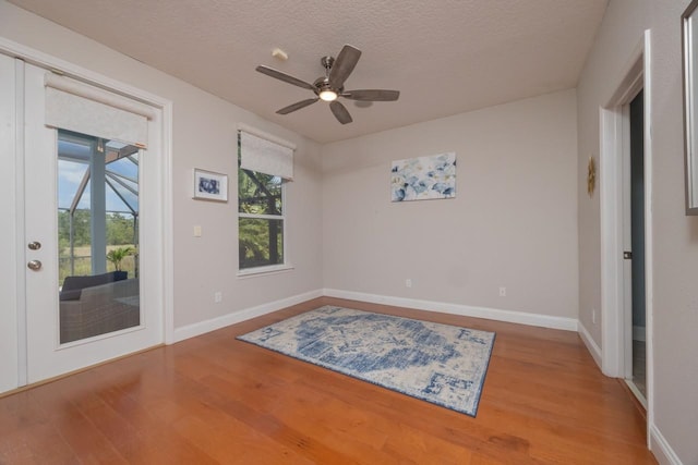 517 Weeping Willow Ln, Saint Augustine, FL 32080 - empty room with wood finished floors, baseboards, a ceiling fan, and a textured ceiling