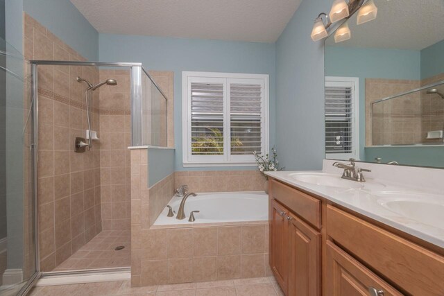 517 Weeping Willow Ln, Saint Augustine, FL 32080 - full bath featuring a shower stall, a garden tub, double vanity, a textured ceiling, and tile patterned flooring