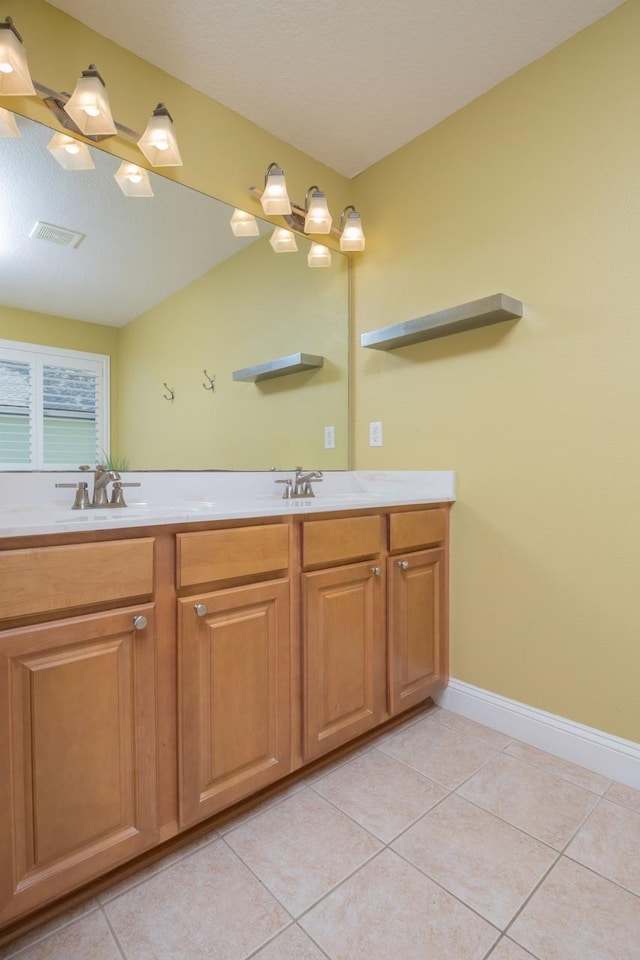 517 Weeping Willow Ln, Saint Augustine, FL 32080 - bathroom with tile patterned flooring, double vanity, and baseboards