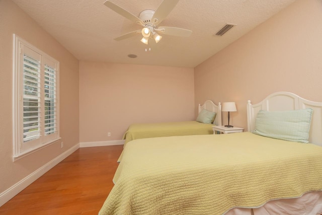 517 Weeping Willow Ln, Saint Augustine, FL 32080 - bedroom featuring wood finished floors, baseboards, ceiling fan, and a textured ceiling